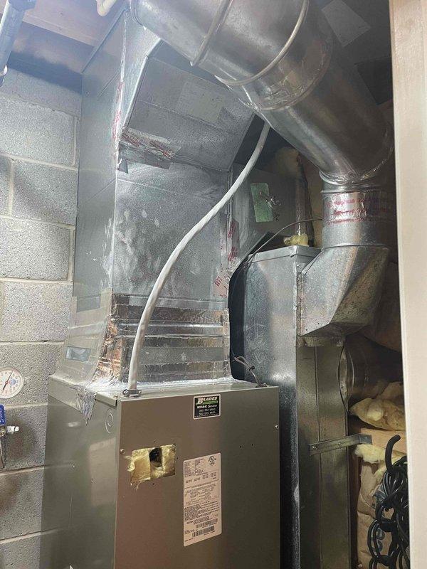 Performed system inspection and heat check on residential HVAC unit. Added 1 lb of 410a refrigerant with UV dye to system to facilitate leak detection. Documented rust discoloration at evaporator coil junction indicating potential moisture exposure requiring future dye inspection for leak confirmation.