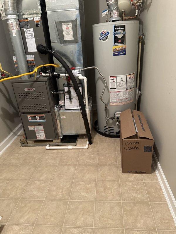 Completed full HVAC system replacement at residential property. Removed and disposed of existing heating and cooling equipment. Installed new Lennox ML180UH090V48BK 80% gas furnace with variable speed blower in interior utility room. Mounted Lennox CK40CT-48B evaporator coil to furnace. Fabricated and installed metal duct transitions to adapt new equipment to existing ductwork. Reused existing condensate drain lines where applicable. Installed Lennox LP conversion kit for proper gas operation.

Positioned new Lennox ML14KC1-042 3.5-ton 14 SEER air conditioner on pressure-treated wood platform at exterior location. Replaced outdoor electrical disconnect and supply whip to meet current code requirements. Reused existing refrigerant line set and electrical power supply from previous installation. Completed all refrigerant connections between outdoor condensing unit and indoor evaporator coil. Evacuated system, pressure tested, and charged with proper refrigerant per manufacturer specifica