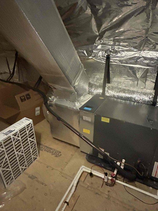 Responded to emergency no-cool call on 9-year-old residential HVAC system. Upon arrival, found thermostat calling for cooling with system running but inadequate temperature drop. Inspected attic-mounted air handler unit and verified proper airflow through supply ductwork. Checked refrigerant lines and connections at air handler, confirmed no visible leaks or damage to copper linesets or insulation. System restored to proper cooling operation with indoor temperature achieving setpoint of 74 degrees as displayed on Honeywell digital thermostat.