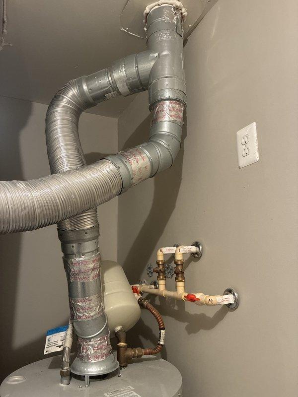 Responded to no hot water complaint following recent water heater installation. Upon arrival, inspected newly installed gas water heater and associated plumbing connections in utility room. Verified all copper supply lines, flexible connectors, and shut-off valves were properly installed and secured. Checked gas supply line connections and confirmed proper venting through metallic flex duct to ensure safe exhaust operation. Identified issue with water heater operation and restored hot water service to residence. All connections tested and verified leak-free, unit now functioning as designed.