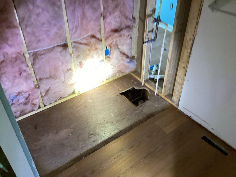 Completed plumbing rough-in for shower/tub installation in residential bathroom renovation. Installed drain assembly through subfloor with proper PVC piping, ensuring correct slope and secure connections for drainage system. Work performed in coordination with ongoing framing and insulation phases of bathroom remodel.