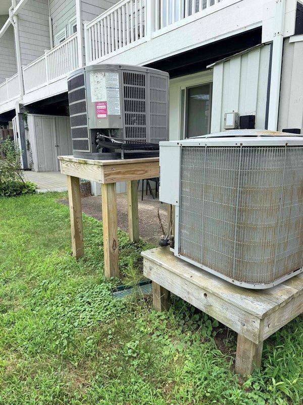 Conducted site assessment for complete HVAC system replacement at residential property. Evaluated existing 15-year-old main house air conditioning system with Carrier air handler located in attic space and outdoor condenser units mounted on wooden platforms, as well as aging ductless mini-split system. Documented current equipment configuration including refrigerant lines, electrical connections, condensate drainage, and outdoor unit placement. Photographed all equipment for replacement quote preparation, specifically focusing on conversion from straight cooling system to heat pump configuration for main house system. Provided homeowner with comprehensive evaluation for dual system replacement to improve efficiency and heating capabilities.