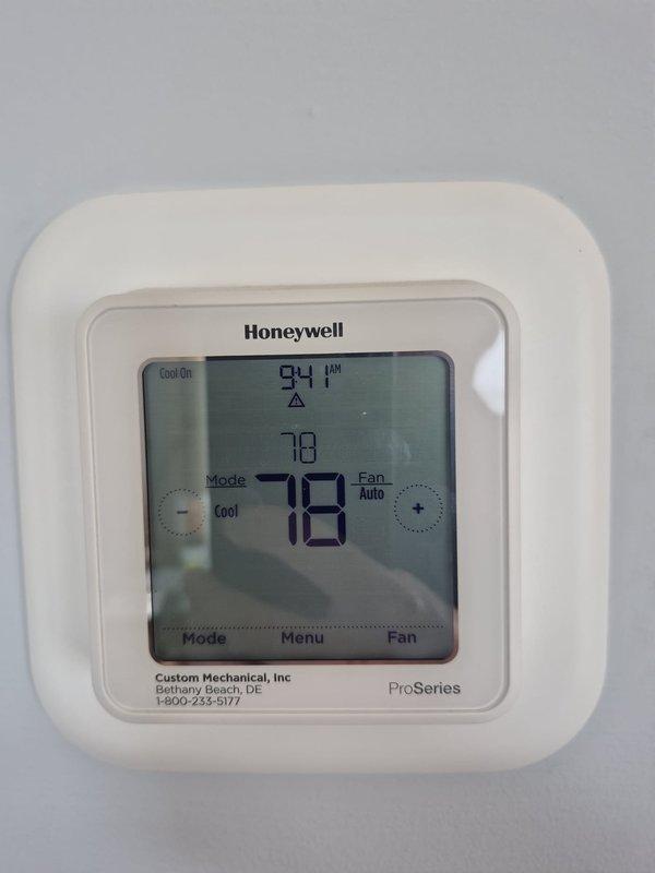 Completed routine heating maintenance visit on residential HVAC system. Verified thermostat operation and programming on Honeywell ProSeries unit, confirming proper temperature readings and system mode functionality. Performed electrical diagnostics on outdoor heat pump unit using clamp meter, measuring amp draw and verifying electrical performance within manufacturer specifications.