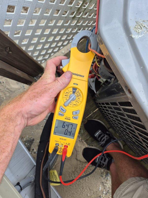 Completed routine heating maintenance visit on residential HVAC system. Verified thermostat operation and programming on Honeywell ProSeries unit, confirming proper temperature readings and system mode functionality. Performed electrical diagnostics on outdoor heat pump unit using clamp meter, measuring amp draw and verifying electrical performance within manufacturer specifications.