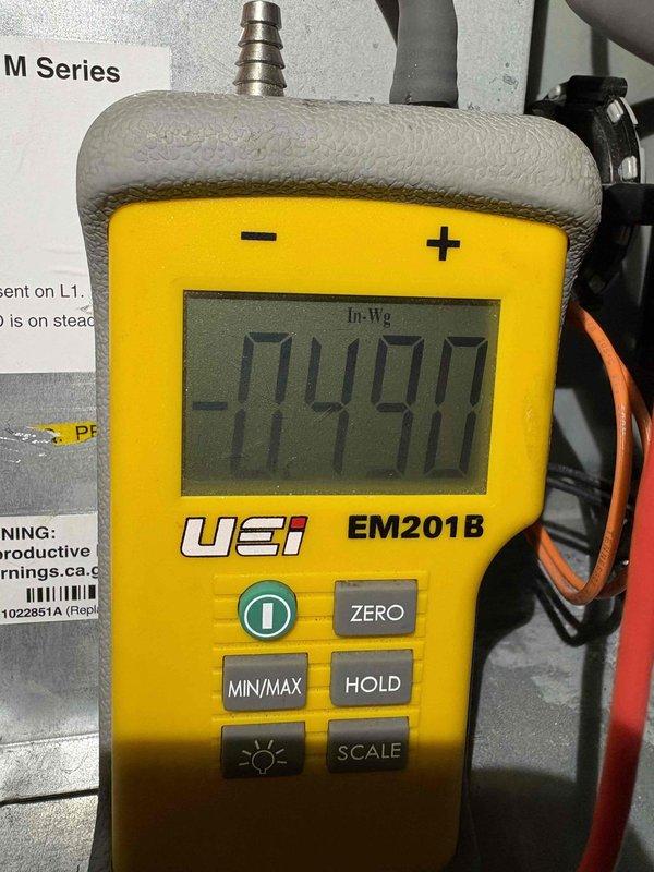 Responded to no heat call on natural gas furnace making noise but not igniting. Upon inspection, measured pressure switch readings using digital manometer (UEi EM201B), which revealed abnormal negative pressure readings of -14990 and -828 inches water column, indicating a significant pressure switch or induced draft blower issue. The furnace was attempting to operate but failing to complete the ignition sequence due to improper pressure switch activation. Diagnosed failed pressure switch or blocked vent system preventing proper draft verification, which caused the safety lockout preventing burner ignition. Performed system diagnostics and pressure testing on the heating system to identify the root cause of the no-heat condition.