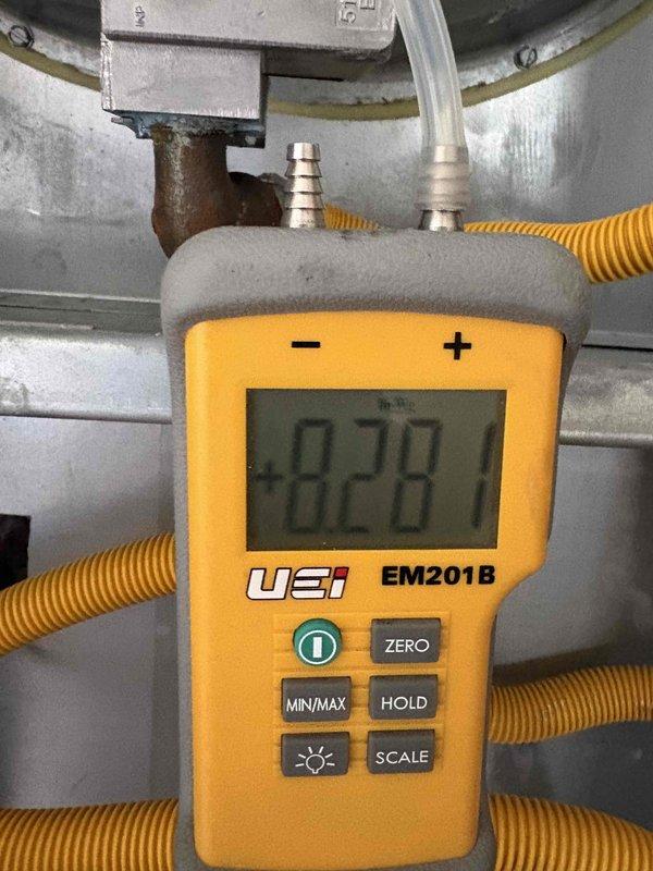 Responded to no heat call on natural gas furnace making noise but not igniting. Upon inspection, measured pressure switch readings using digital manometer (UEi EM201B), which revealed abnormal negative pressure readings of -14990 and -828 inches water column, indicating a significant pressure switch or induced draft blower issue. The furnace was attempting to operate but failing to complete the ignition sequence due to improper pressure switch activation. Diagnosed failed pressure switch or blocked vent system preventing proper draft verification, which caused the safety lockout preventing burner ignition. Performed system diagnostics and pressure testing on the heating system to identify the root cause of the no-heat condition.