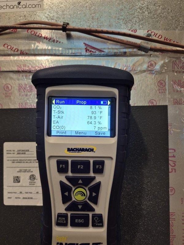 Completed heating system maintenance and diagnostic testing. Verified thermostat operation showing proper display function with indoor temperature at 73°F and setpoint at 75°F. Performed combustion analysis using diagnostic equipment, recording CO2 levels at 8.1%, stack temperature at 93°F, ambient air temperature at 78.9°F, excess air at 64.3%, and carbon monoxide at 7 ppm, confirming safe and efficient operation within acceptable parameters.
