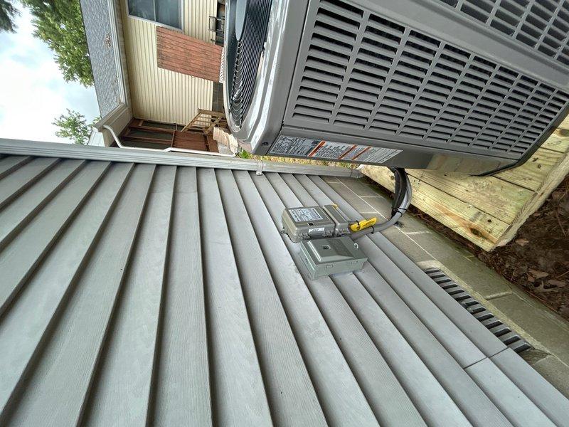 Completed full HVAC system replacement including removal and disposal of existing equipment. Installed 5A6H7024 2-ton 17 SEER heat pump on outdoor platform with surge disconnect and whip. Installed 5TEM6B02 variable speed fan coil unit in attic with drain pan and shut-off valve. Integrated BAYHTR1510BRKR 10KW electric heater with breaker into air handler. Flushed, pressure tested, and recharged refrigeration lines to manufacturer specifications. Installed THX1200W WiFi thermostat for system control. Verified all electrical connections, tested system operation across all modes, and confirmed proper airflow and temperature differentials. System operational with one-year parts and labor warranty on new equipment.