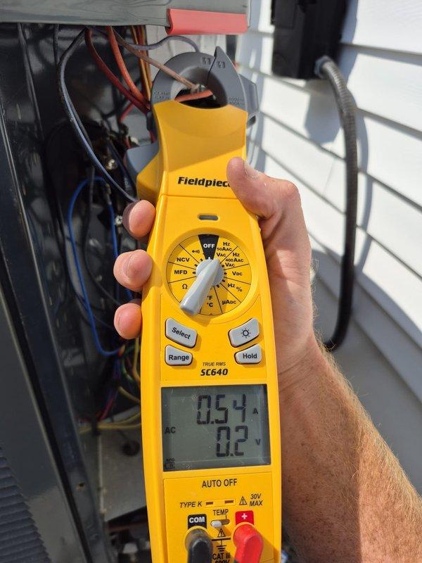 Completed routine heating system maintenance visit and performed comprehensive diagnostic testing. Used clamp meter to verify electrical readings, measuring 0.54 amps and 0.2 volts at the HVAC unit, and confirmed 119V supply voltage with proper amperage draw of 41 amps at the main system components. All electrical connections, blower assembly, and system wiring inspected and found operating within normal parameters.