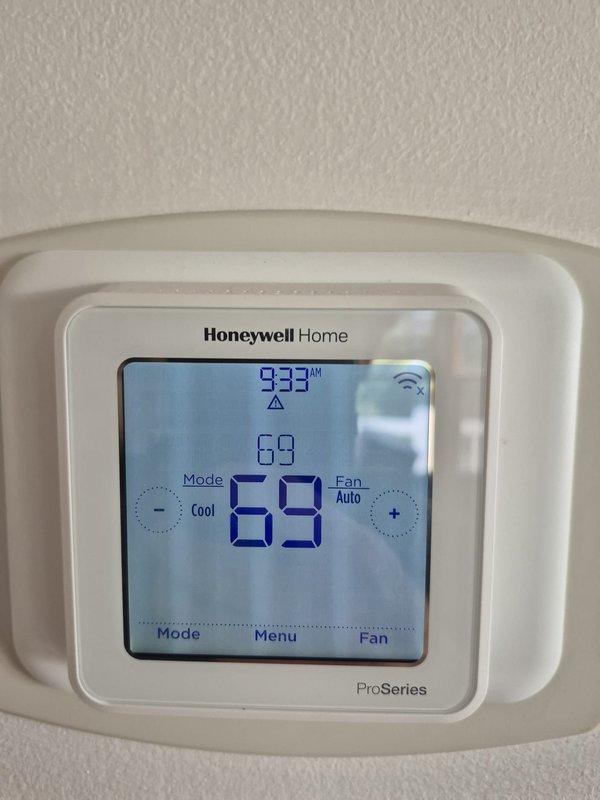 Completed scheduled heating maintenance visit and system inspection. Verified thermostat operation and calibration on Honeywell Home ProSeries unit, confirmed proper temperature settings and wireless connectivity functioning correctly. Performed electrical diagnostics on heating system components using digital multimeter, recorded voltage readings within normal operating parameters at 200.5V, and verified all electrical connections secure throughout air handler unit.