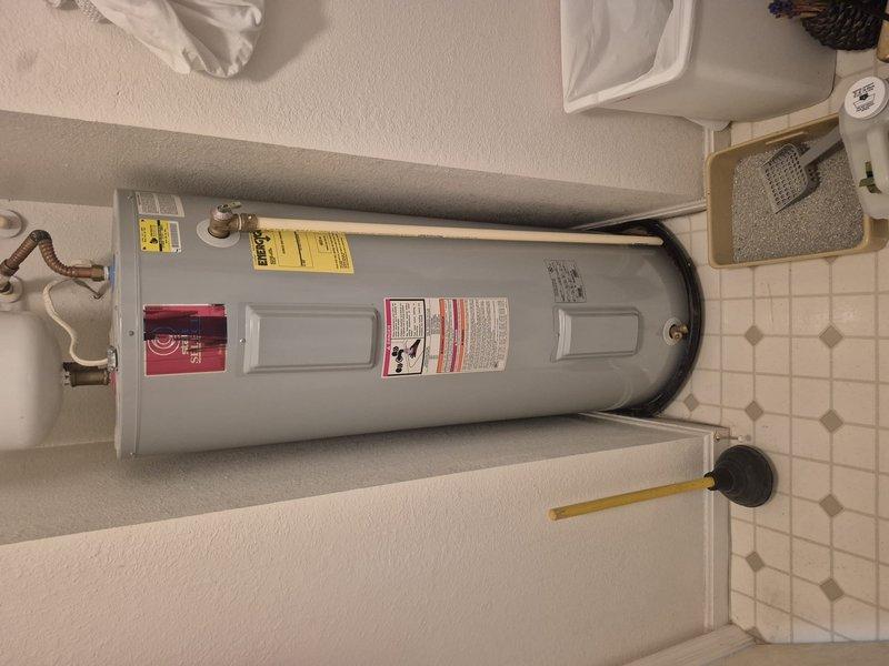 Conducted on-site evaluation of non-operational residential water heater located in first-floor utility closet. Upon arrival, shut off water supply and partially drained the existing unit to assess condition and prepare for replacement estimate. Inspected current installation including water heater tank, associated copper and PVC plumbing connections, shut-off valves, flexible connector lines, and water treatment system. Documented existing configuration with photographs for replacement planning and proper sizing recommendations.