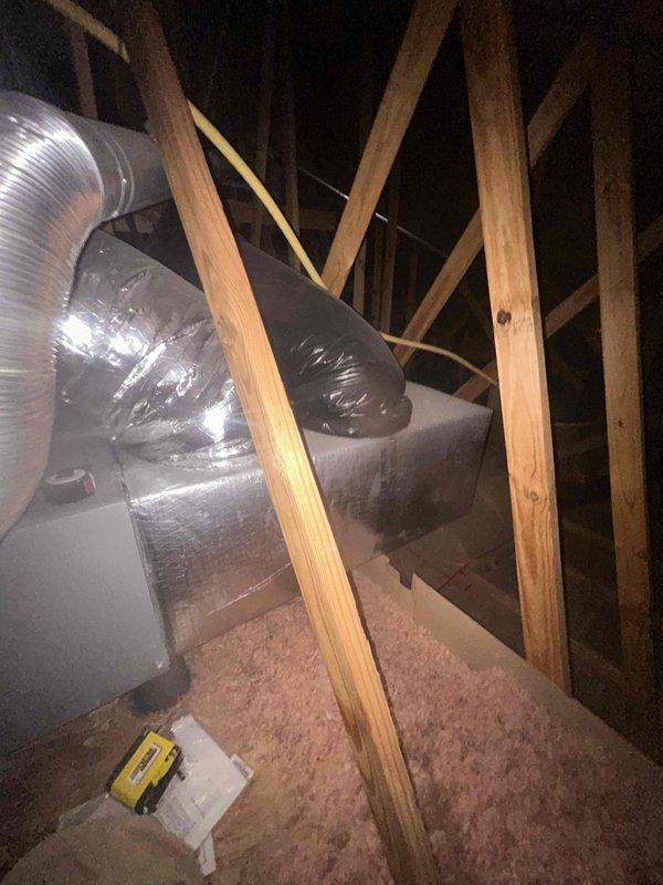 Responded to no cooling call on residential split system. Upon arrival, found outdoor condenser unit operational but system not achieving setpoint with indoor temperature rising. Performed diagnostics including refrigerant charge verification, measuring superheat at 150°F and subcooling at 15% below target parameters. System was shut down to prevent compressor damage. Inspected attic-mounted air handler and ductwork for airflow restrictions or equipment malfunctions. Documented equipment conditions with photos showing outdoor unit placement and attic installation configuration for further assessment and repair recommendations.