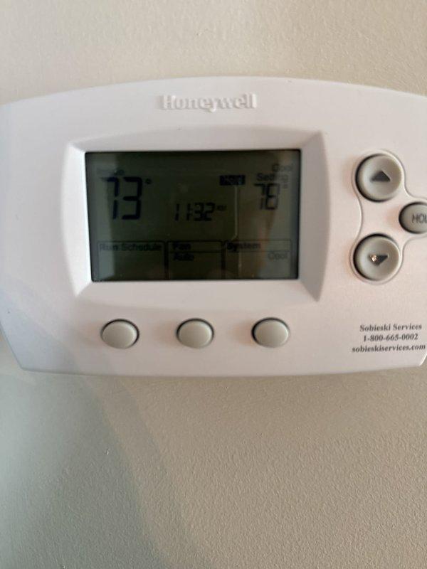 Performed heating system check on HVAC unit with Honeywell digital thermostat. Verified thermostat operation, confirmed proper display functionality showing accurate temperature readings and system settings, and documented system status with unit currently set to cooling mode with fan on auto. All components functioning within normal parameters at time of inspection.