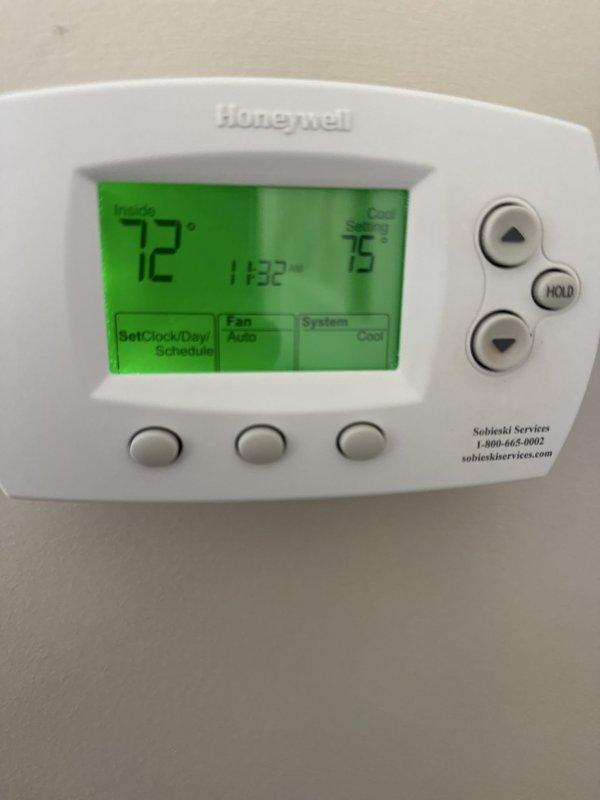 Performed heating system check on HVAC unit with Honeywell digital thermostat. Verified thermostat operation, confirmed proper display functionality showing accurate temperature readings and system settings, and documented system status with unit currently set to cooling mode with fan on auto. All components functioning within normal parameters at time of inspection.