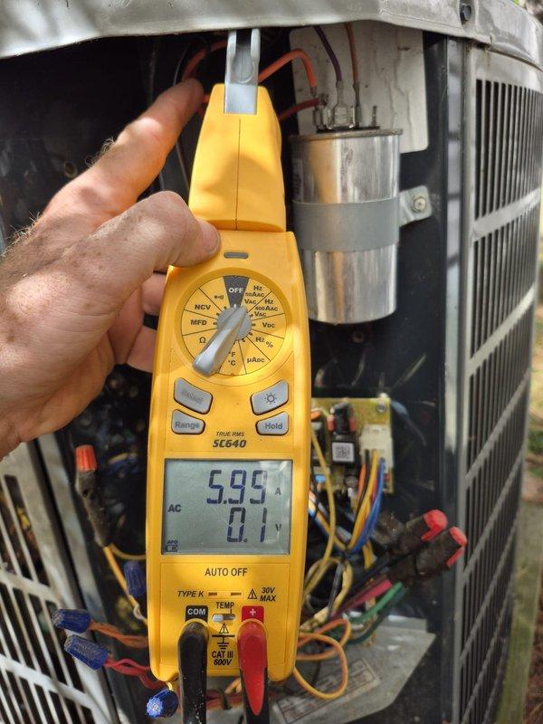 Performed preventive maintenance cooling visit on residential HVAC system. Conducted electrical diagnostics using multimeter, verifying voltage and amperage readings on condensing unit components. Inspected capacitor, wiring connections, and compressor operation. All electrical values within manufacturer specifications at 595V and 0.92A. System operating properly with no deficiencies noted.
