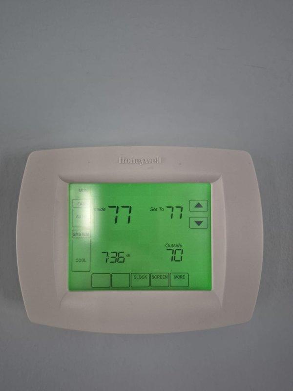 Completed routine cooling maintenance on two HVAC systems. Performed system diagnostics, verified thermostat operation showing 77°F indoor temperature with proper display functionality, and tested electrical components including fuses and safety switches using digital multimeter to ensure proper voltage and continuity. All systems operating within normal parameters.