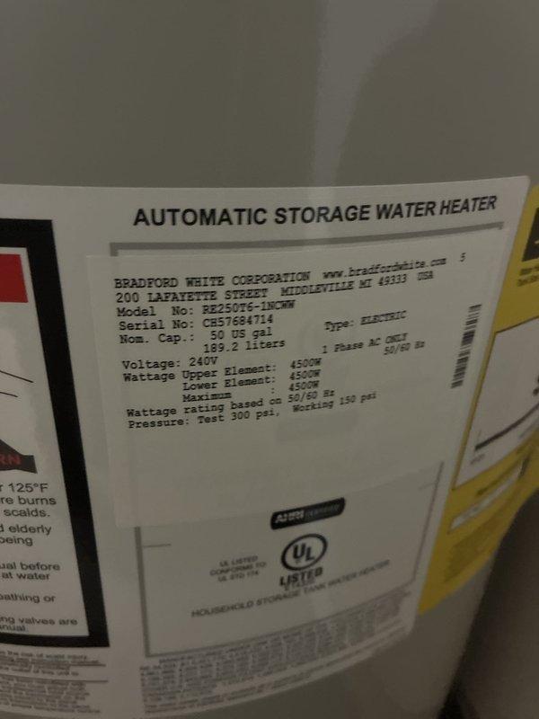 Installed a Bradford White 50-gallon electric water heater (model PE250T6-1NCWW) with 4500W dual heating elements rated for 240V operation. Installation included a 22-inch drain pan for leak protection, thermal expansion tank to accommodate system pressure fluctuations, and complete plumbing connections using brass fittings (3/4" nipples in 2" and 6" lengths, 90-degree elbow, tee fitting), high-temperature rated dielectric unions, and 18-inch flexible water connectors. Unit was integrated with existing water filtration system and properly configured with shut-off valves for safe operation and future maintenance access.