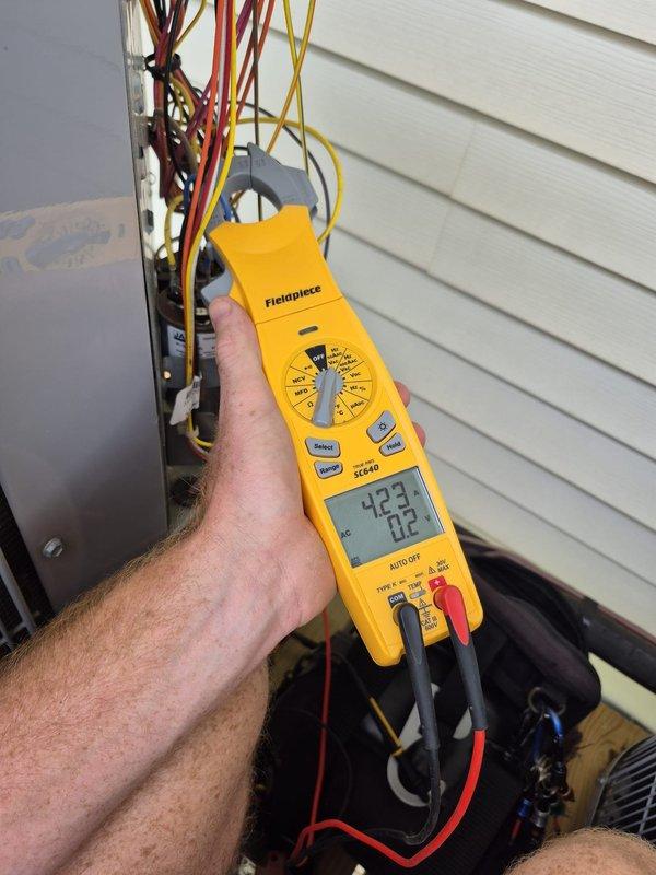 Completed comprehensive tune-up inspection on three systems: two conventional HVAC units and one Daikin ductless mini-split system. Performed diagnostic testing on outdoor unit electrical components, verifying proper voltage and amperage readings at 423V. Inspected Daikin FTXV09AV-JU9 indoor fan coil unit (serial Y309558), confirming R32 refrigerant system operating within manufacturer specifications with proper high-side and low-side pressure ratings. All systems evaluated for performance, safety, and efficiency standards.