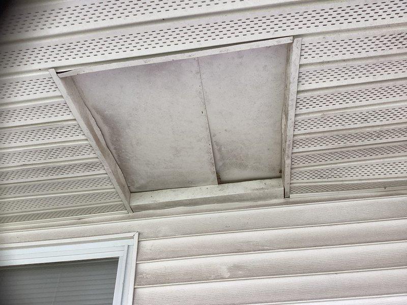 Conducted comprehensive site assessment for HVAC system replacement at residential property with attic access via ladder. Evaluated existing outdoor condensing unit positioned on wooden platform and inspected soffit ventilation panel for proper attic airflow considerations. Documented current equipment configuration and structural access points to prepare detailed replacement estimate for complete system upgrade.