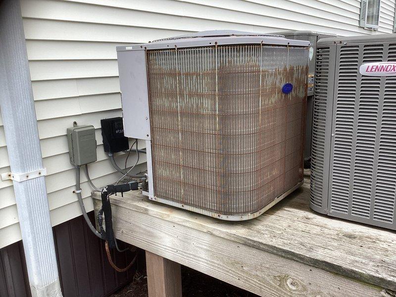 Conducted site evaluation for replacement of 1.5-ton HVAC system in third-floor residential unit. Assessed existing aging outdoor condensing unit showing significant weathering and deterioration, documented air handler location in hallway closet, and verified electrical panel capacity for new equipment installation. Provided comprehensive replacement estimate for complete system upgrade.