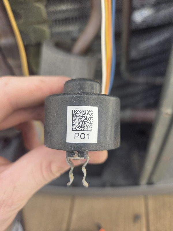 Completed scheduled heating maintenance visit and system inspection. Performed diagnostic testing using digital multimeter, recording temperature readings of 67.98°F at equipment location. Inspected and documented electronic sensor component (P01) with QR code tracking label for quality assurance purposes. Verified all electrical connections, refrigerant lines, and rubber hoses for proper operation and integrity. System operating within normal parameters with no issues identified.