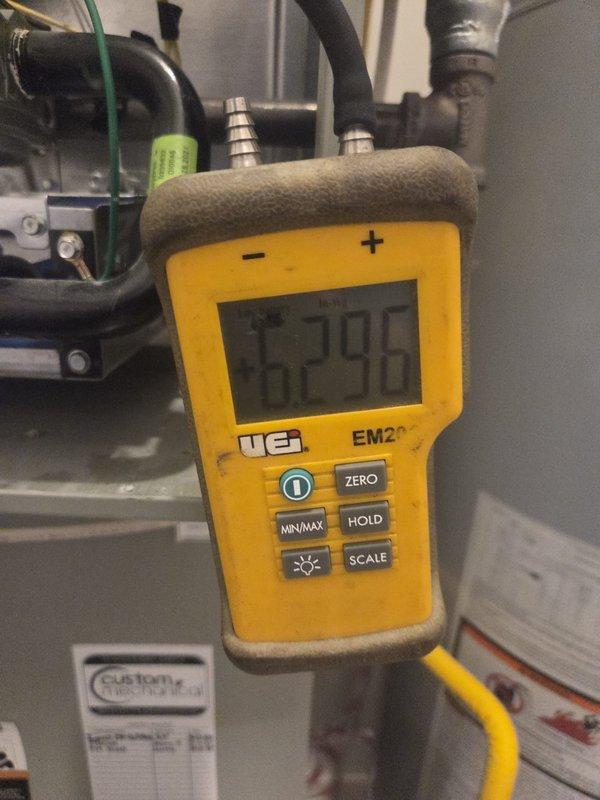 Completed scheduled heating maintenance visit and system inspection. Performed diagnostic testing using digital multimeter, recording temperature readings of 67.98°F at equipment location. Inspected and documented electronic sensor component (P01) with QR code tracking label for quality assurance purposes. Verified all electrical connections, refrigerant lines, and rubber hoses for proper operation and integrity. System operating within normal parameters with no issues identified.