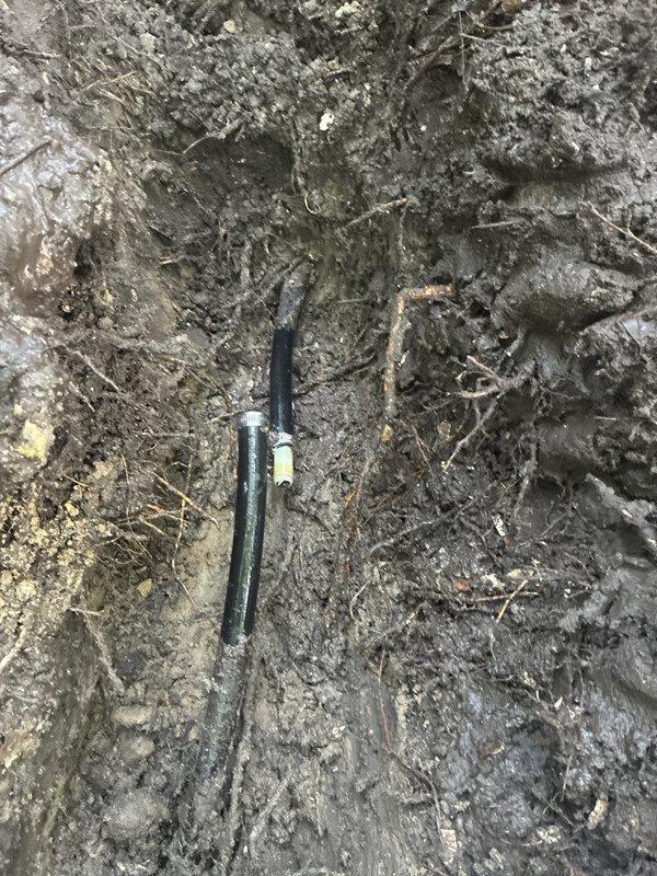 Completed main water line service repair by excavating to expose the damaged section of the supply line. Installed repair clamps with stainless steel hose clamps to secure the compromised pipe section and restore water service integrity. Backfilled the trench with excavated soil and hand raked the surface to grade level, completing the emergency repair and restoring full water service to the property.