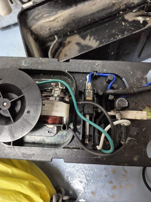 Responded to no cooling complaint with blank thermostat display. Located HVAC unit and accessed internal components for diagnosis. Upon inspection, found failed blower motor with damaged windings and associated electrical components requiring replacement. Removed section of drywall to access thermostat wiring and traced power supply issue from equipment to wall-mounted control. Identified multiple system failures including motor assembly and capacitor. Documented equipment condition with photos showing internal components, wiring configuration, and wall access points for repair coordination.