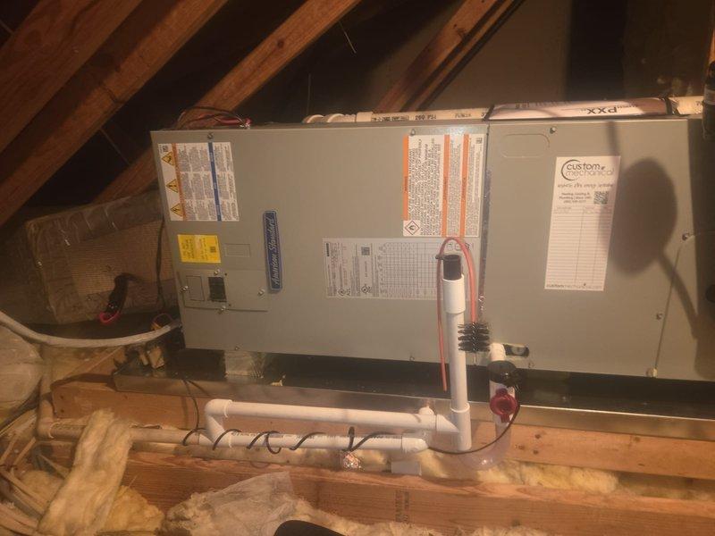Removed and disposed of the existing equipment and installed a new American Standard 2-ton 14 SEER heat pump with matching air handler, 10 kW electric heat package, filter rack, and Honeywell WiFi thermostat. Fabricated and installed metal duct transitions to adapt to the existing ductwork, replaced the outdoor disconnect and electrical whip, and reused the existing electrical, condensate, and power lines. Replaced the drain pan and float switch, and set the outdoor unit on a plastic pad with snow legs.