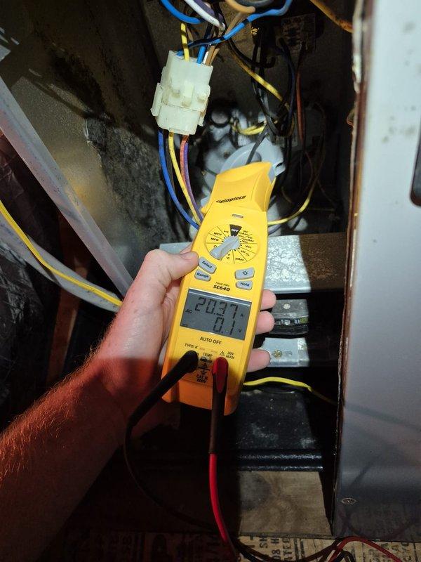 Performed scheduled heating maintenance on the system, including electrical testing of the control and power circuits using a clamp meter to measure amperage draw on the unit's wiring and components. Inspected the electrical compartment, wiring harness, and contactor/capacitor components, and checked the surrounding insulated ductwork and condensate PVC drain line in the attic space. System operation was verified, with no further issues noted at completion.