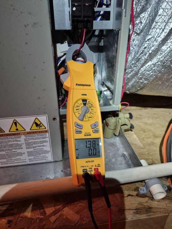 Performed a scheduled heating maintenance visit on the air handler, including inspection of the electrical compartment and measurement of blower circuit amperage with a clamp meter to verify normal operating draw. Checked supply duct discharge temperature at the foil-faced insulated trunk using a digital probe thermometer, recording 74.1°F, and inspected the condensate drain pan and PVC drain line for proper condition.