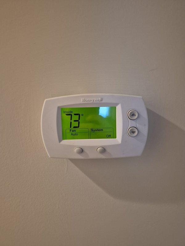Performed scheduled heating maintenance on two systems, verifying thermostat operation (system set to off, fan on auto, indoor temperature 73°F) and inspecting the control cabinet wiring, connections, and circuit board. Measured amperage draw with a true RMS clamp meter (3.75 A on the tested conductor) and observed no signs of frost, rust, or visible damage.