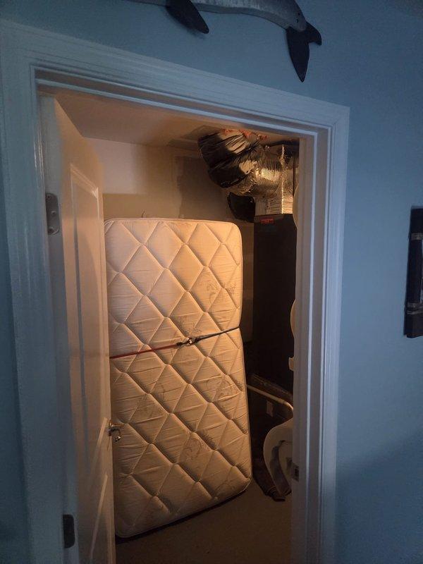 Performed scheduled seasonal heating maintenance on a vertical air handler located in an interior utility closet, inspecting the cabinet, supply plenum, and flexible ductwork connections and verifying the condensate drain piping and sealed duct joints. Access to the unit was limited by stored items in the closet, and the system was cleared for operation with no deficiencies noted.