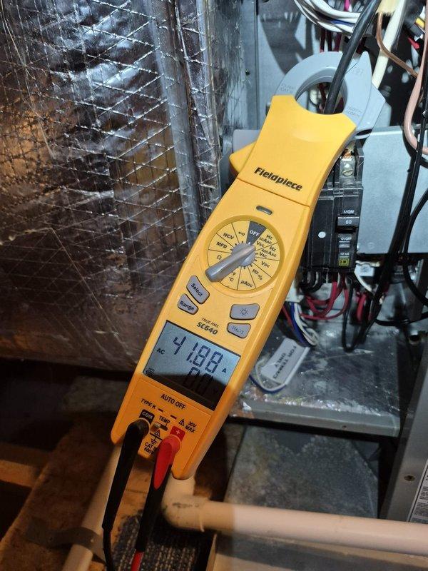 Performed scheduled heating maintenance inspection on two systems and verified thermostat operation and system controls, with the thermostat in a permanent hold at a 78° setpoint and the system in cool mode at the time of visit. Measured electrical load with a clamp meter, recording approximately 41.9 amps AC at the electrical disconnect, and inspected the surrounding ductwork, condensate piping, and wiring for damage, with no anomalies found.