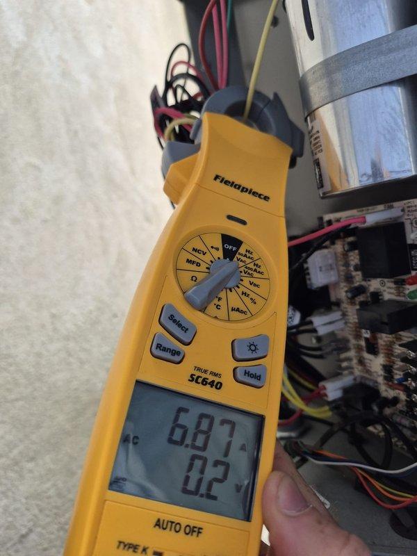 Performed a scheduled heating system inspection and verified operation of the furnace/air handler electrical components. Measured amperage draw with a true RMS clamp meter (readings of approximately 3.0 A and 6.87 A on the monitored circuits), and visually inspected the capacitor, control board, relays, and wiring connections, finding no signs of damage, corrosion, or overheating. System was left operating normally with thermostat set to 68°F.