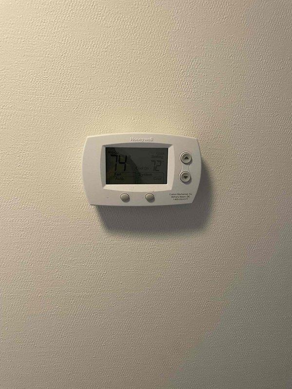 Performed a tune-up inspection on one HVAC system, including a heating and cooling operational check. Verified thermostat functionality, with the system responding properly in cooling mode and maintaining setpoint, and inspected the electrical service panel and breakers serving the equipment. Noted dust buildup, corrosion at the panel cover and screw heads, and loose hardware at the panel, which may warrant further evaluation.