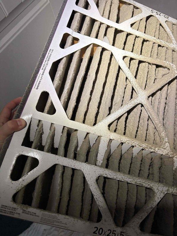 Responded to an emergency call for a blank thermostat and water in the furnace pan on a ten-year-old unit. Inspection found a heavily clogged 20x25x5 media filter loaded with dust and debris that had restricted airflow and contributed to the water accumulation and loss of system operation. Replaced the dirty filter, cleared the water from the pan, and restored the system to normal operation.