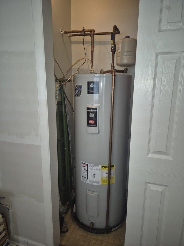 Assessed the existing electric water heater and its closet installation, including the copper supply piping, expansion tank, drain valve, and wiring, to estimate relocating the unit. Also evaluated the site for a possible tankless conversion and discussed options with the customer.
