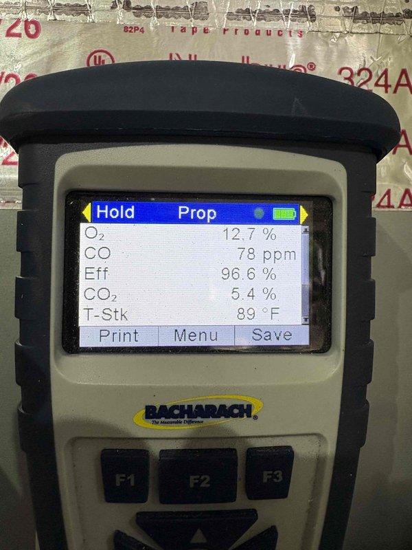 Performed an indoor air quality inspection in response to a musty odor near the water heater, evaluating the condensate drain line for blockage and verifying heating system operation. Combustion analysis in heating mode returned O₂ 12.7%, CO 78 ppm, CO₂ 5.4%, 96.6% efficiency, and 89°F stack temperature, confirming the system is operating properly. Inspection of the duct/plenum interior revealed heavy microbial growth on the fibrous insulation board, indicating a likely source of the odor and a need for remediation.