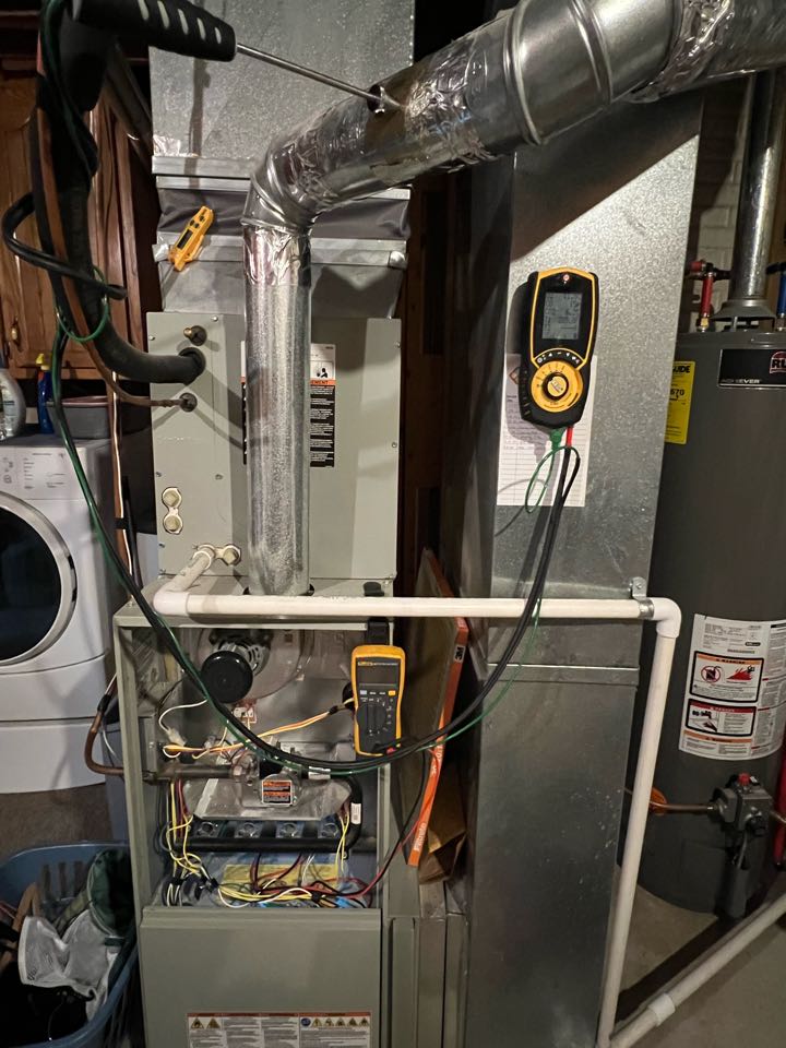 Performing a planned maintenance inspection of a Trane 80 percent gas furnace and a complimentary water heater inspection on a Ruud water heater. Performing a combustion analysis on the furnace. Inspecting burners, ignitor, and flame sensor. Changing the filter. Checking temp rise on equipment and inspecting flue pipes. Also testing the water heater PSI, heating cycle, wiring and venting. 