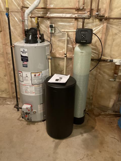 Holmen, WI - Upon arrival, the homeowner reported an unpleasant odor coming only from the refrigerator water dispenser. After inspecting the system, our technician cleaned the Rusco sediment filter, which resolved the issue. During a complete evaluation of the home's water treatment equipment, it was determined that the existing water softener had reached the end of its service life. The customer chose to upgrade to a new Capital CP100-32 Water Softener for improved water quality and reliability. As a proactive measure, they also elected to replace their aging water heater with a new Bradford White 40-Gallon LP Power Vent Water Heater. Both installations were completed with a professional turnkey installation, and the new equipment was tested to ensure proper operation.
