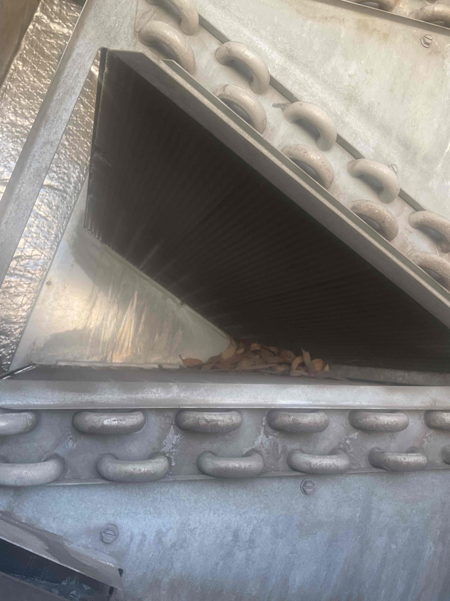 Upon inspection, the evaporator coil was found to be significantly dirty, which can affect the efficiency and performance of the system. Additionally, the blower wheel panel inside the return air duct, adjacent to the evaporator coil, was completely unsecured. This unsecured panel allowed outside air to enter the system, compromising indoor air quality and potentially leading to further complications. I carefully cleaned the dirty evaporator coil, ensuring all debris and buildup were removed. Subsequently, I secured the blower wheel panel, preventing any unwanted outside air from entering the system. These actions will enhance the system's efficiency and maintain optimal indoor air quality.