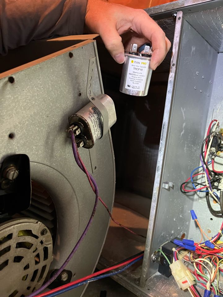 Goodman and Trane heat pump heating maintenance with a blower motor run capacitor replacement. 