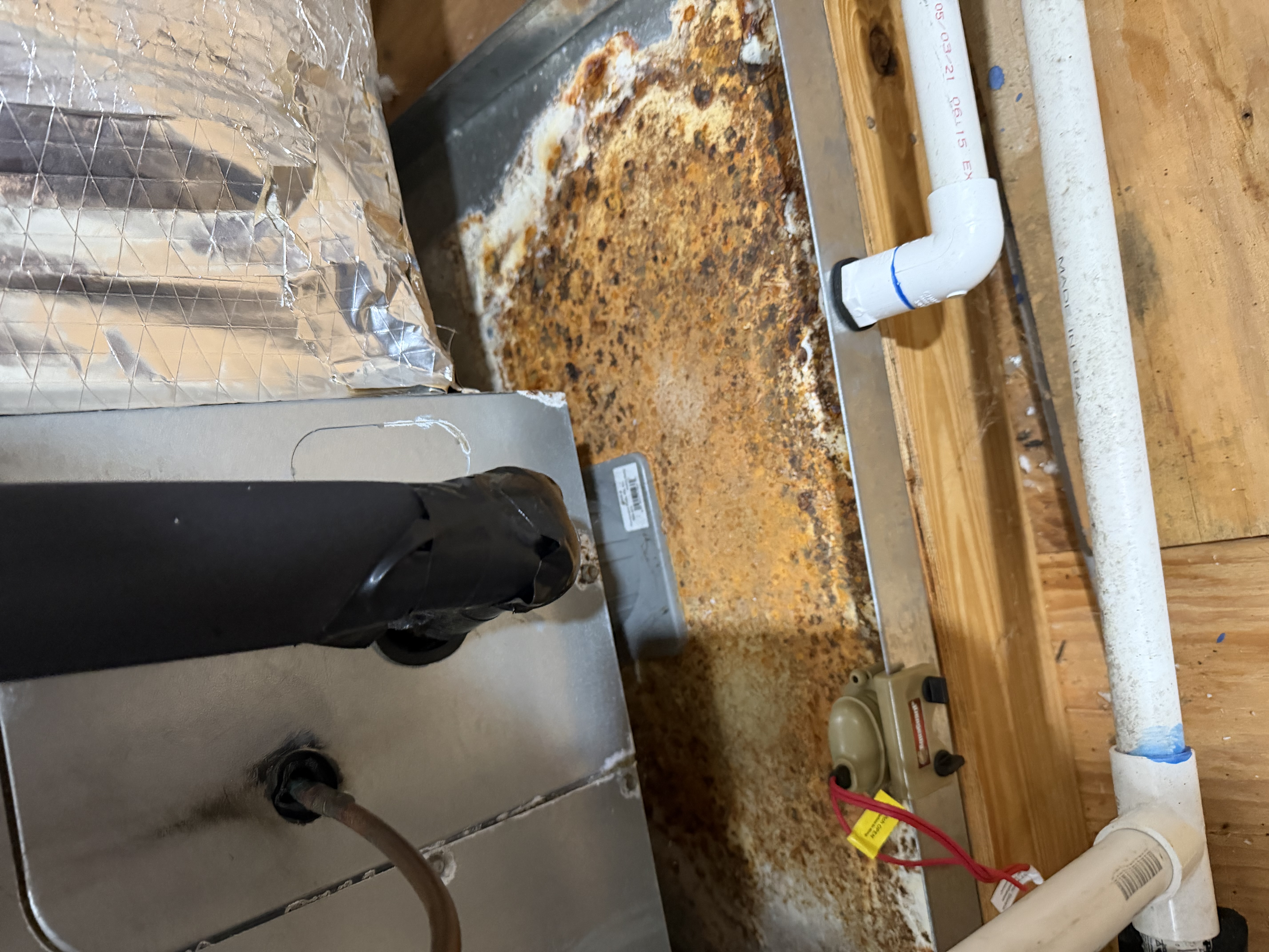 A/C maintenance on Trane airhandler and heat pump. Drain pan with minor rust. 