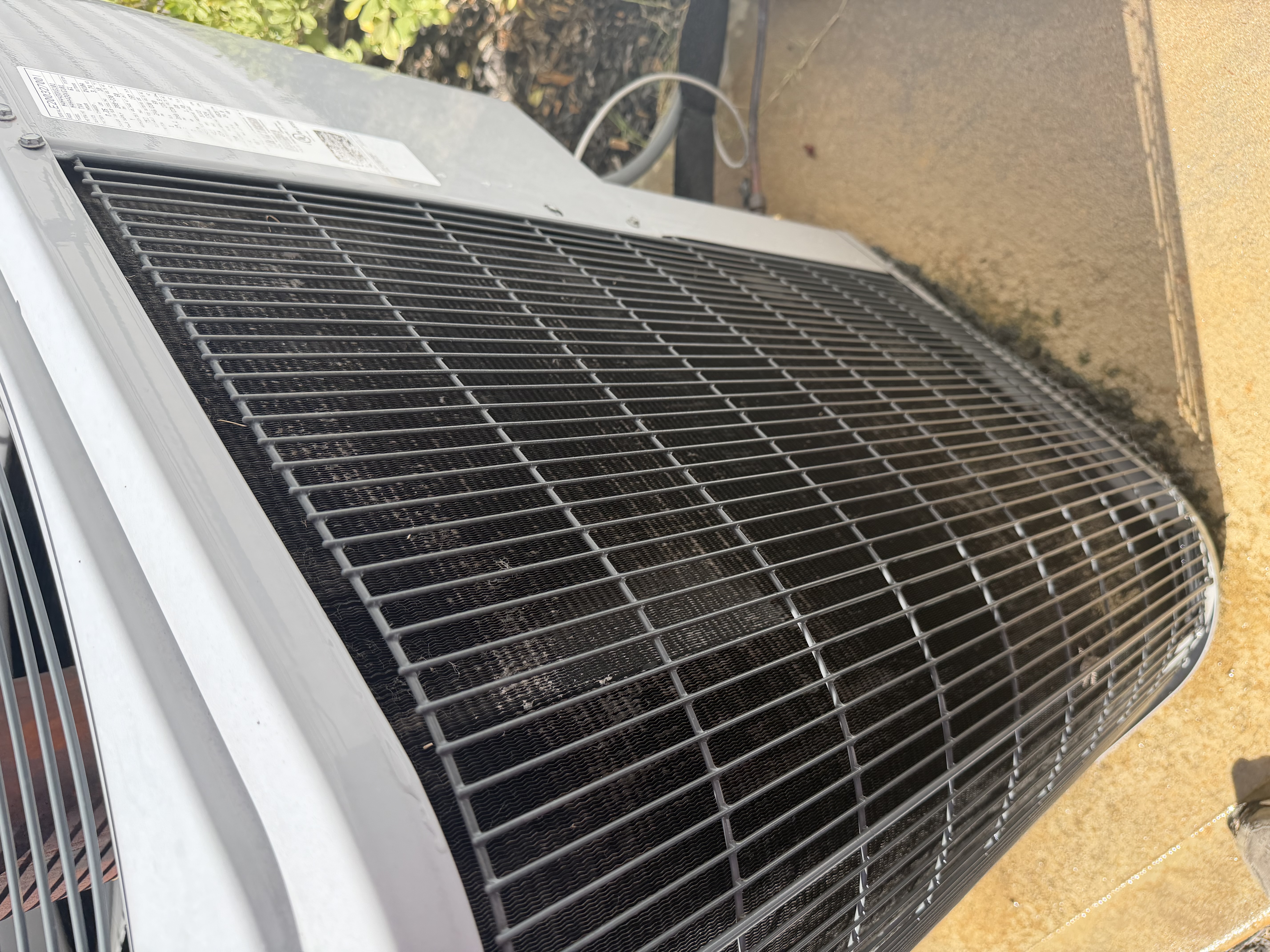 A/C maintenance on a carrier heat pump. Picture of cleaned condenser coils. 