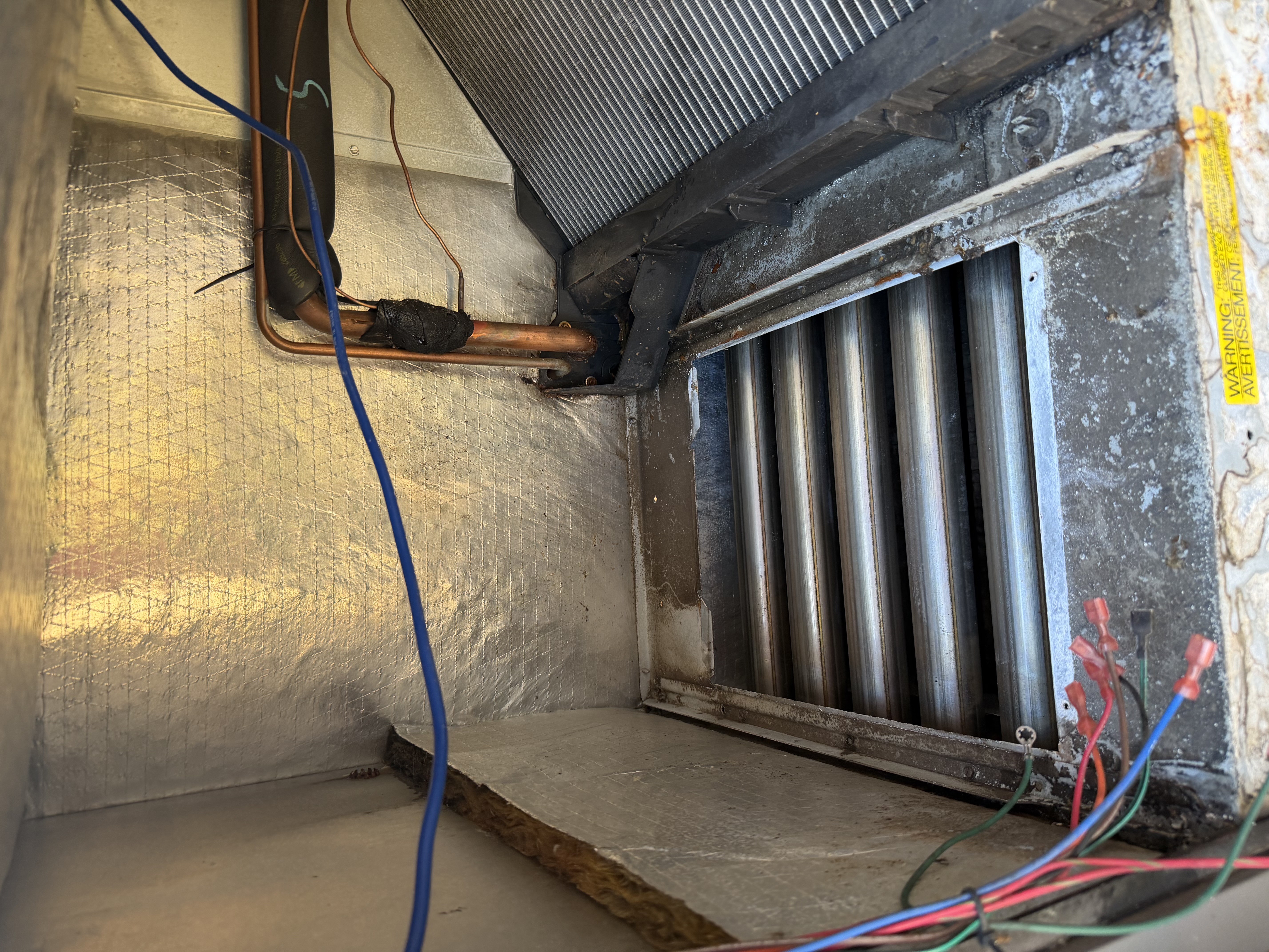 Performed heat maintenance on Rheem Package Unit. Picture of heat exchanger and cleaned flame sensor. 
