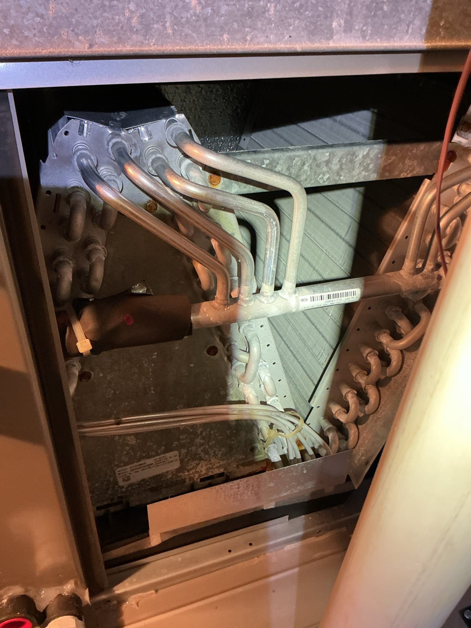 Performed Top Rank air conditioning and furnace maintenance in Wixom, Michigan, on a system approximately nine years old. Completed full furnace maintenance, including cleaning the flame sensor, blower wheel, condensate P-trap, and between the burner ports; combustion analysis was good, with readings attached to the invoice. Air conditioning maintenance was completed with good refrigerant readings and overall operation; a high inrush amp draw was noted, so a quote for a soft-start kit will be provided, with no further work needed at this time.