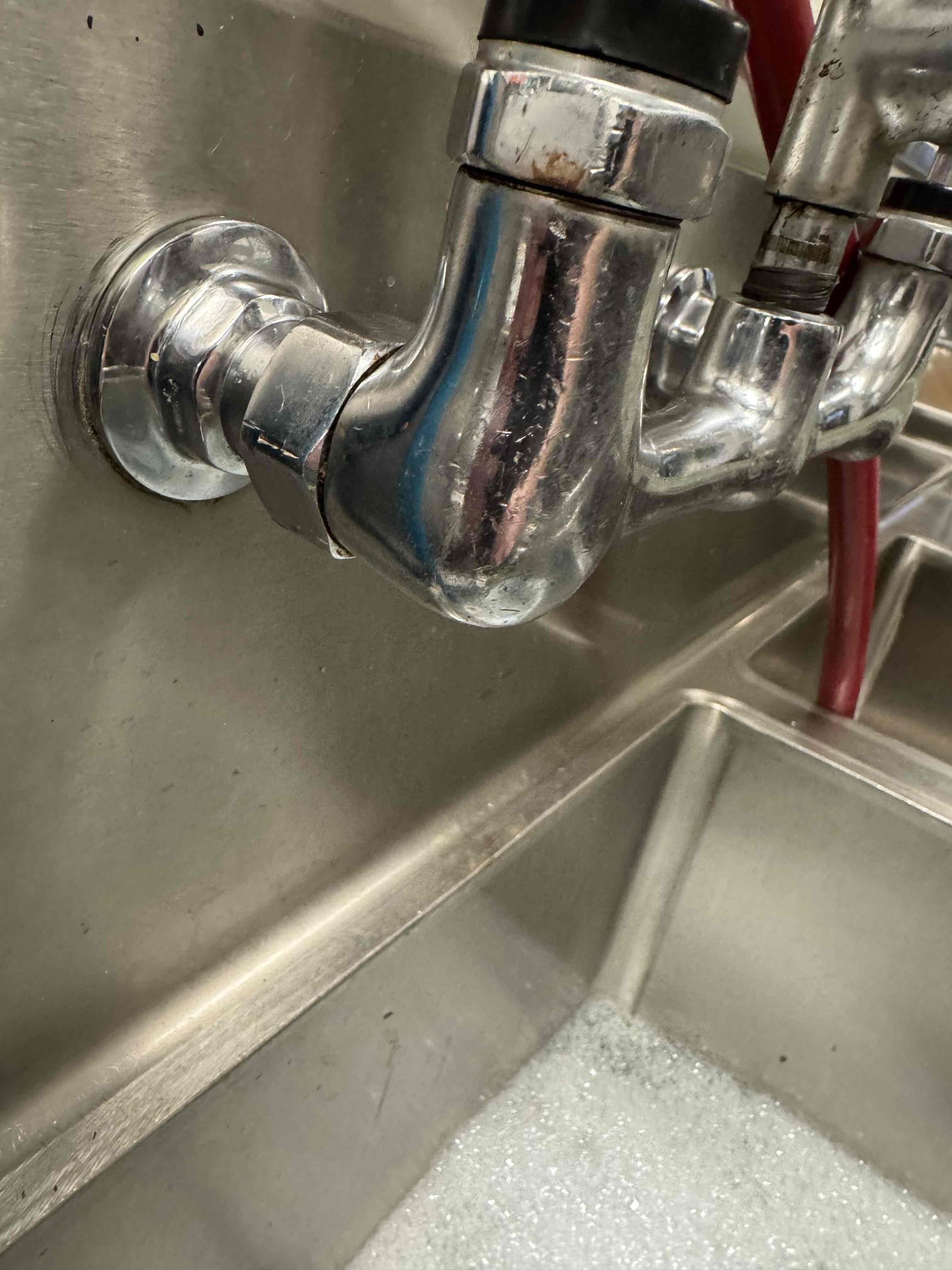 Upon inspection, I identified a leak originating from the hot water side of the three-component faucet union. I carefully tightened the connection to rectify the issue, ensuring it was secure and leak-free. Throughout the process, I maintained communication with Manager Trey, who was present on site to oversee the work. The repair was completed efficiently, restoring the faucet's functionality.