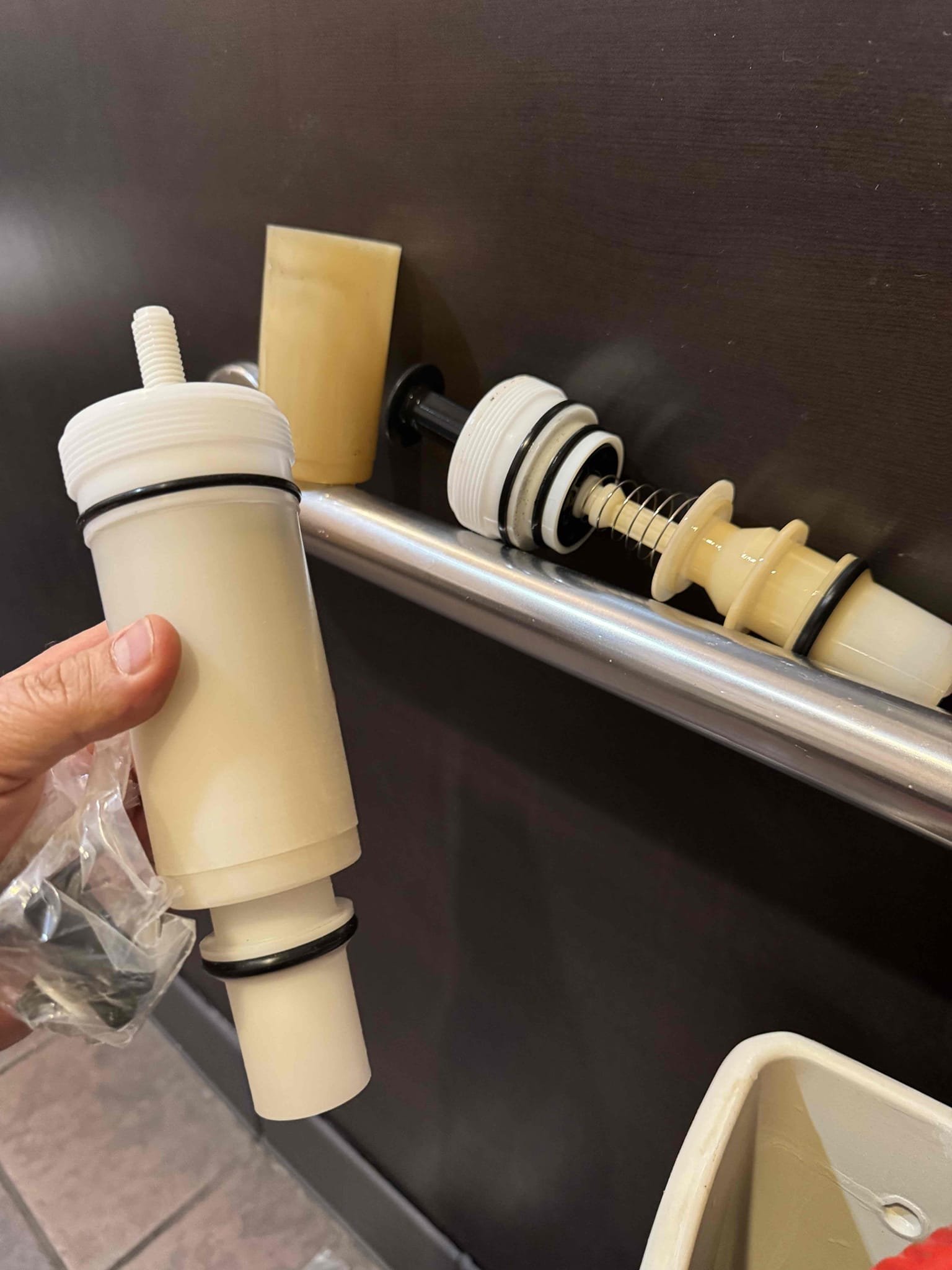 Upon inspection, the bathroom toilet's flush cartridge was found to be broken, preventing proper flushing. I replaced the old, malfunctioning cartridge with a new Sloan Flushmate cartridge. This ensured the toilet would flush effectively. The installation was completed successfully, and the toilet is now functioning as intended. The job was signed off by Tristen, confirming the resolution of the issue.