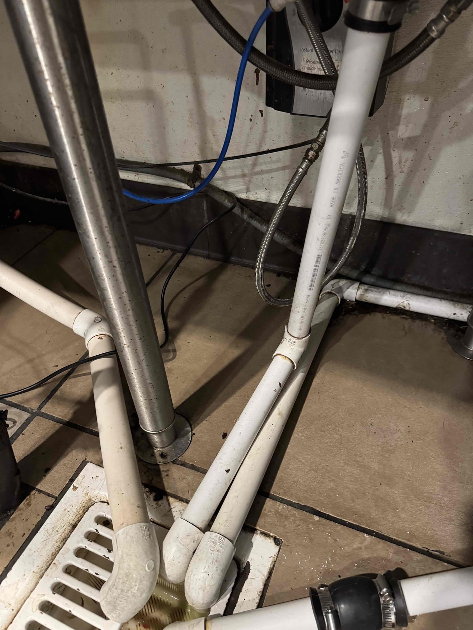 Upon inspection, the drain line for the ice bin was found to be improperly positioned, lying on the floor instead of draining into the floor sink. To rectify this, I extended the drain pipe to ensure it reaches the sink properly. Additionally, I incorporated a flexible section using a 1-1 1/4 inch Fernco coupling, which allows for movement and prevents breakage during cleaning. This modification ensures the drain line will function correctly and remain intact. The work was completed efficiently, and I signed for Eric to confirm the job's completion.
